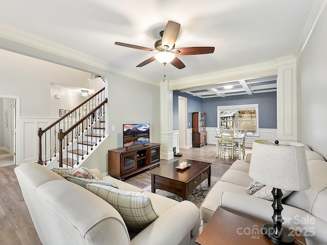 living room with beamed ceiling, ornamental molding, ceiling fan, and coffered ceiling