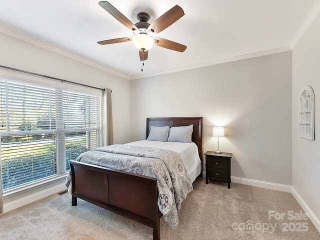 carpeted bedroom with ceiling fan and crown molding