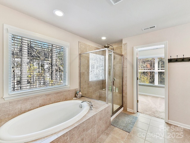 bathroom with tile patterned floors and independent shower and bath