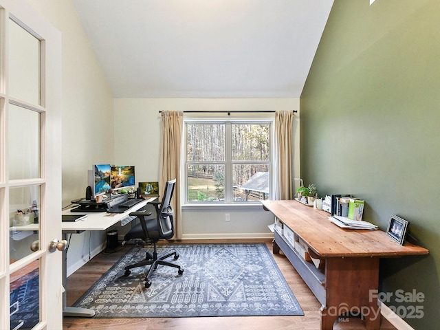 office space featuring hardwood / wood-style flooring and lofted ceiling