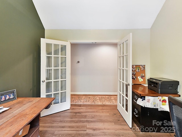 office area featuring hardwood / wood-style floors, lofted ceiling, and french doors