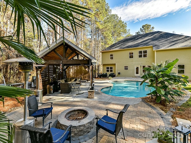 view of swimming pool with a gazebo, a patio, and an outdoor fire pit