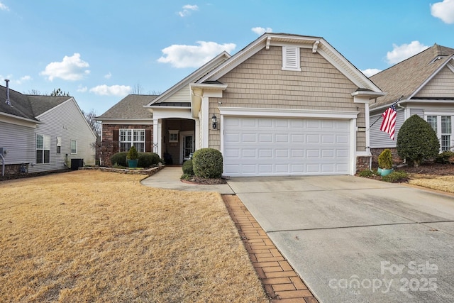 view of front of home featuring central AC unit, a garage, and a front lawn