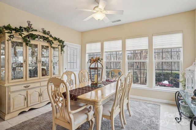 tiled dining area featuring ceiling fan