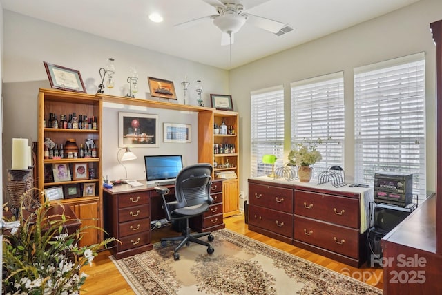 office space featuring light hardwood / wood-style floors and ceiling fan