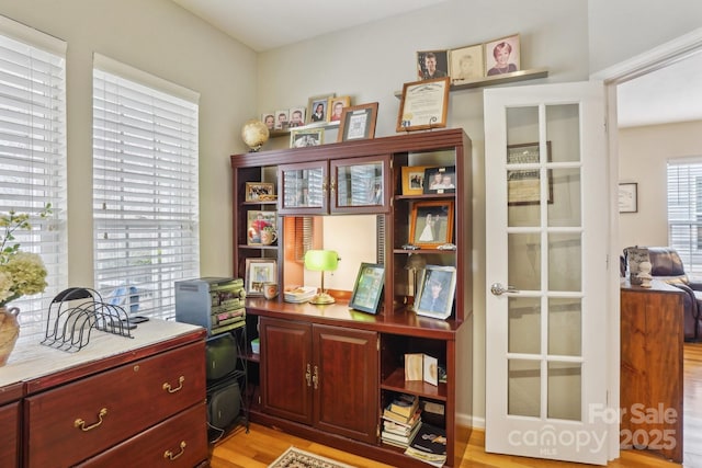 office area with light hardwood / wood-style floors