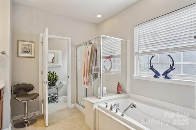 bathroom with vanity and independent shower and bath