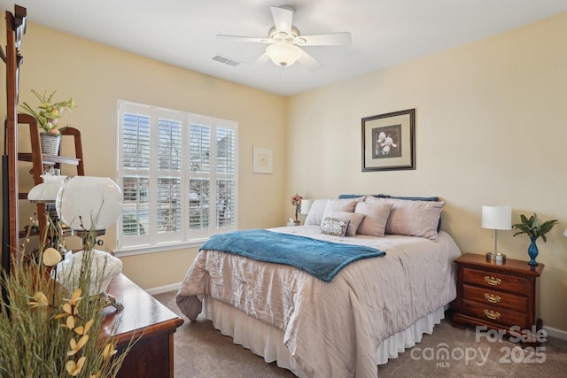 carpeted bedroom featuring ceiling fan and multiple windows