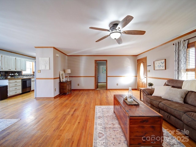 unfurnished living room with light hardwood / wood-style flooring, ornamental molding, ceiling fan, and plenty of natural light