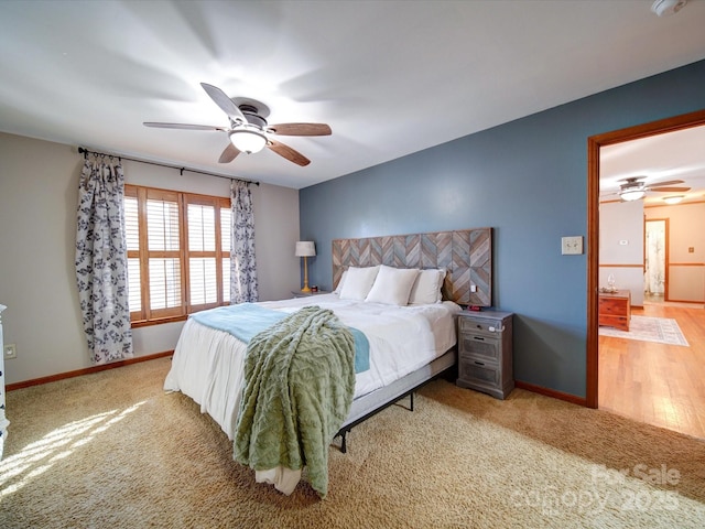 bedroom with ceiling fan and light colored carpet