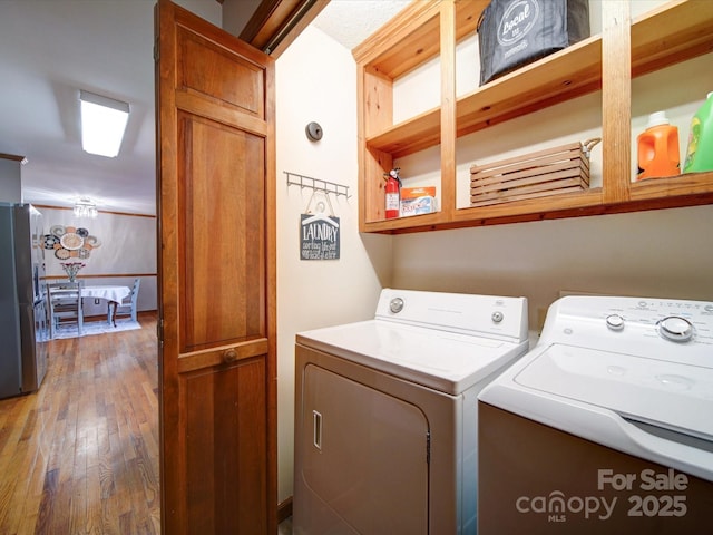 washroom featuring washing machine and dryer and hardwood / wood-style floors