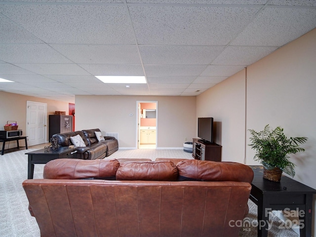 carpeted living room with a drop ceiling