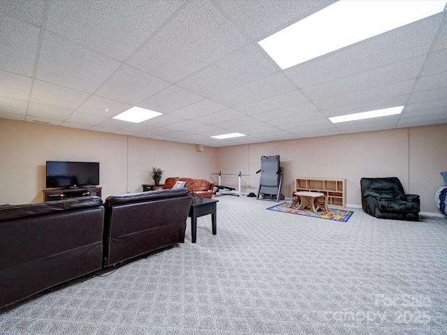 carpeted living room featuring a paneled ceiling