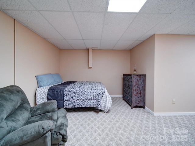 carpeted bedroom with a drop ceiling