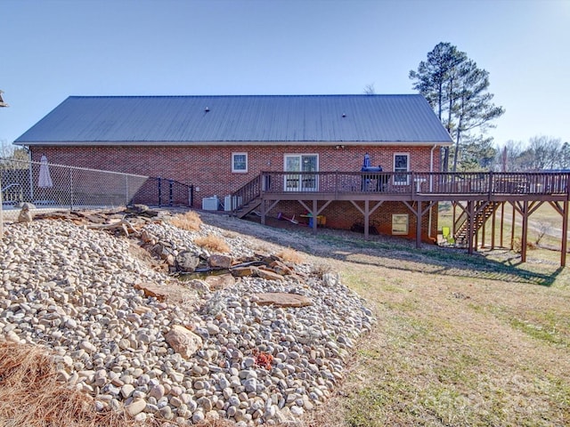 back of property featuring a deck