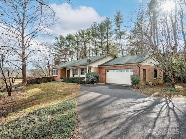 single story home with a front lawn and a garage