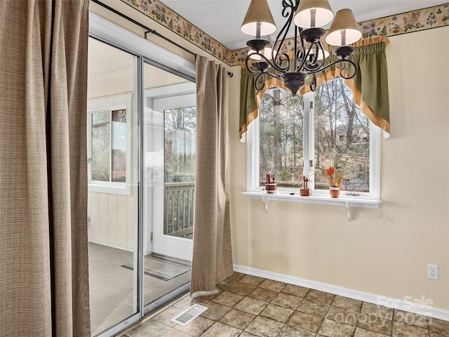 unfurnished dining area featuring a notable chandelier