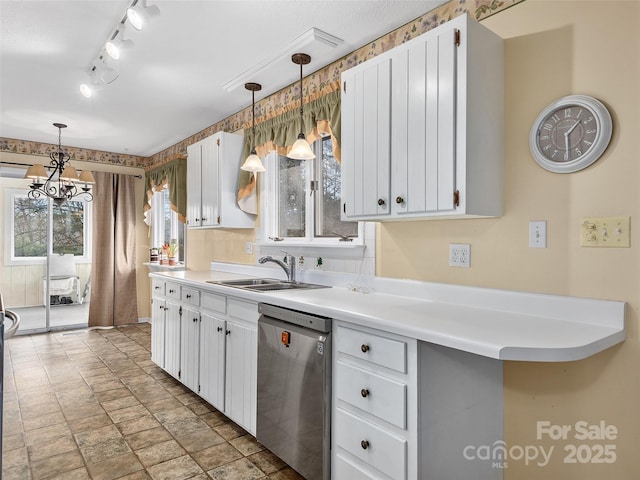 kitchen with dishwasher, white cabinets, sink, hanging light fixtures, and a notable chandelier