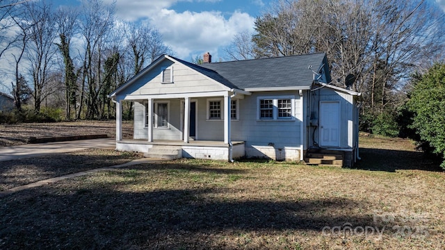 bungalow-style house with a porch and a front yard