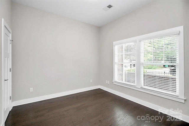 unfurnished room with hardwood / wood-style flooring and a wealth of natural light