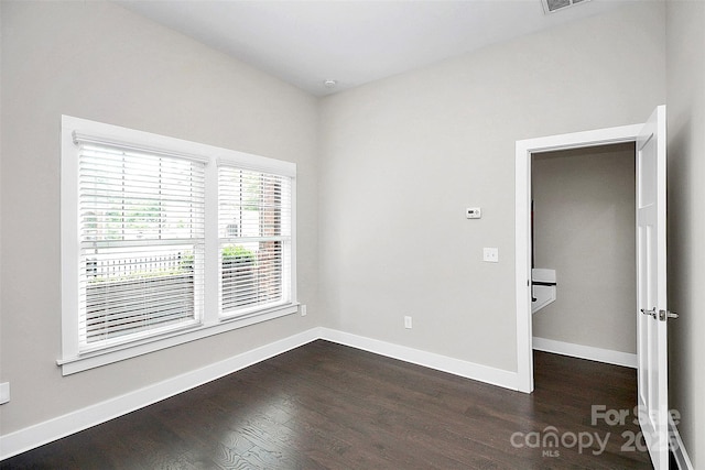 spare room with dark hardwood / wood-style flooring