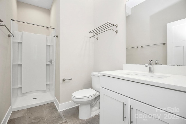 bathroom featuring vanity, toilet, and walk in shower