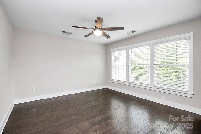 unfurnished room with plenty of natural light, dark wood-type flooring, and ceiling fan