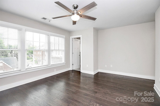 spare room featuring ceiling fan and dark hardwood / wood-style flooring