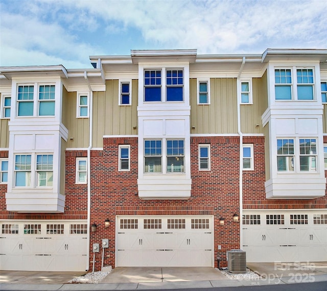 view of front of house featuring cooling unit and a garage