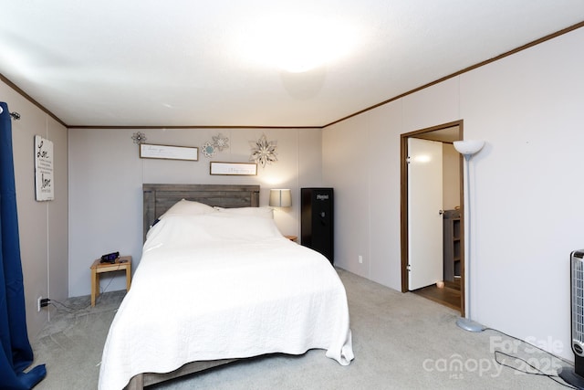 bedroom with carpet floors and ornamental molding