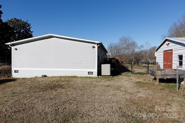 view of side of home with cooling unit and a lawn