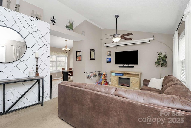 living room featuring ceiling fan with notable chandelier, light colored carpet, and vaulted ceiling