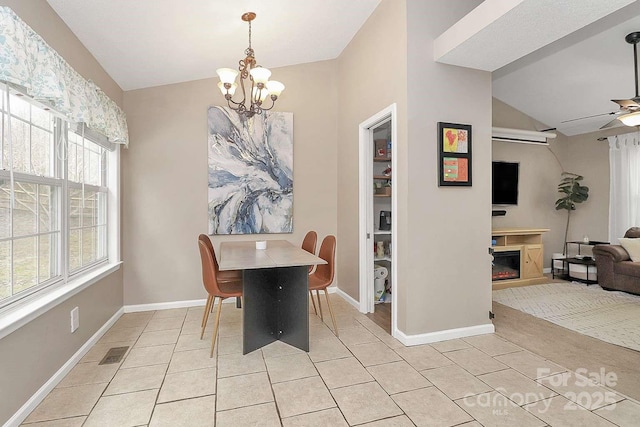 dining room with vaulted ceiling, ceiling fan with notable chandelier, and light tile patterned floors