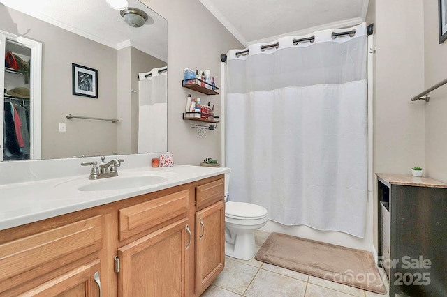 bathroom with vanity, tile patterned floors, crown molding, and toilet