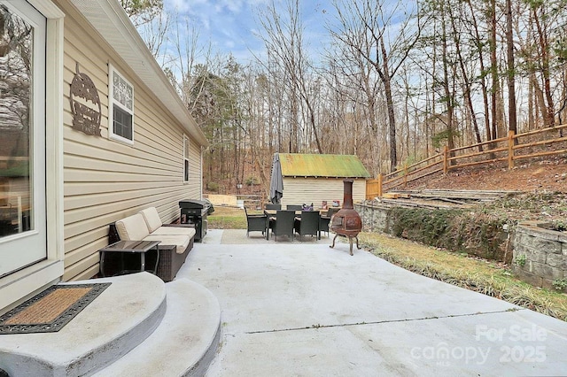 view of patio / terrace featuring grilling area and a shed