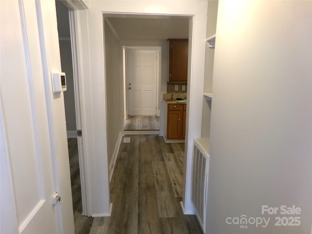 corridor with dark hardwood / wood-style floors