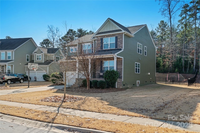 view of front of property featuring a porch and a garage