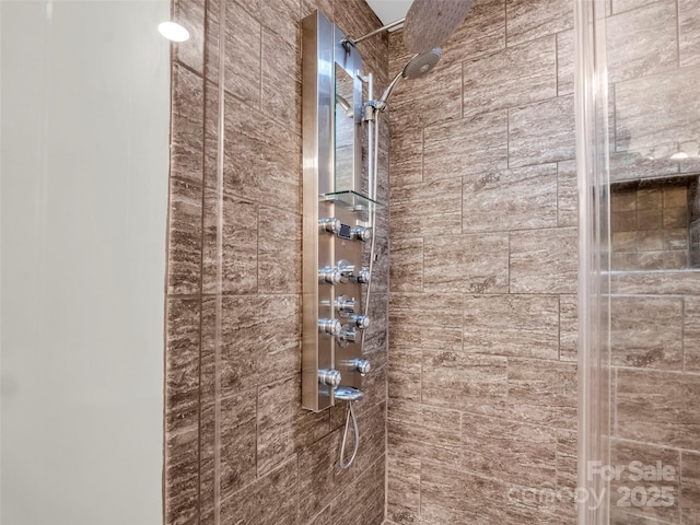 bathroom with tiled shower