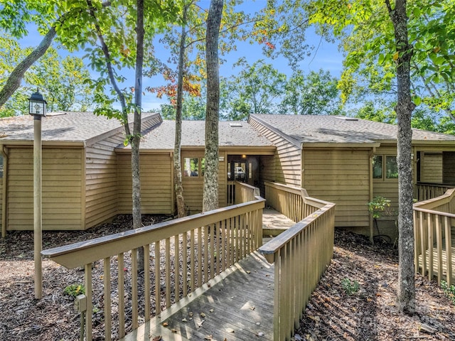 back of house featuring a wooden deck