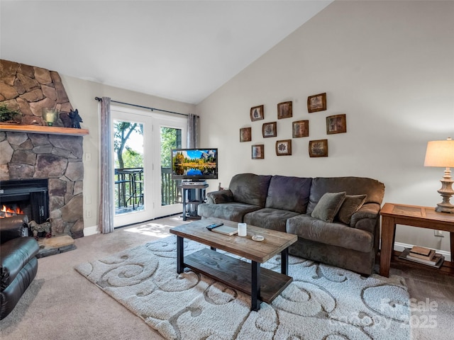 living room with carpet, high vaulted ceiling, and a fireplace