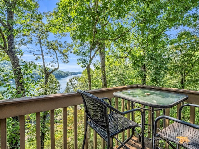 wooden terrace featuring a water view