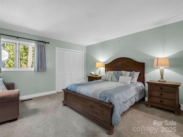 carpeted bedroom with a closet