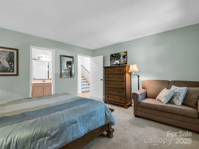 carpeted bedroom with ensuite bathroom