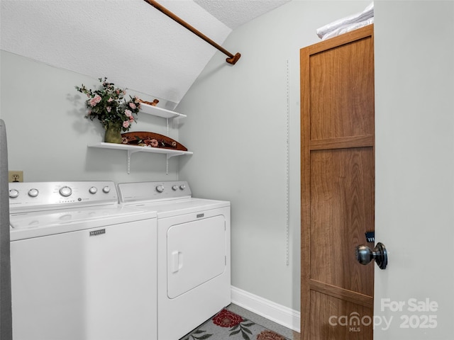 clothes washing area with a textured ceiling and independent washer and dryer