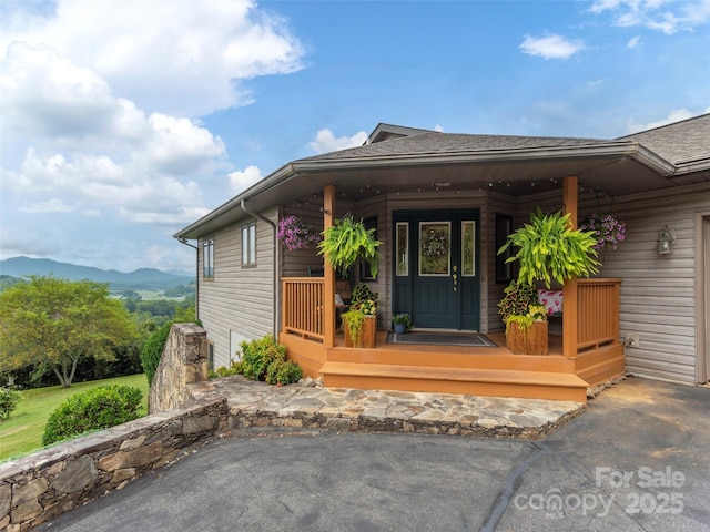 entrance to property featuring a mountain view and a porch