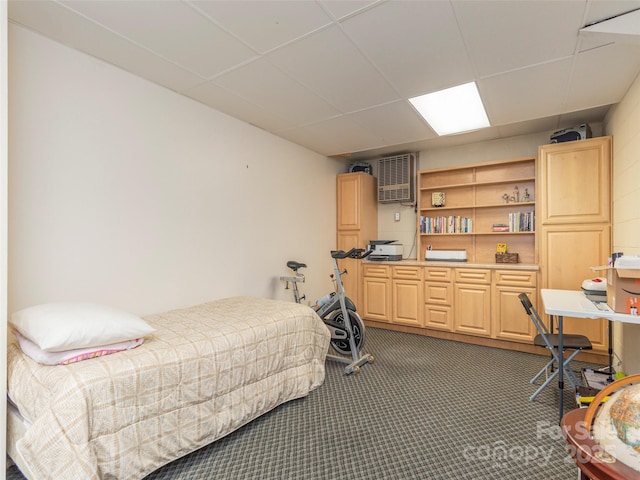 carpeted bedroom featuring a paneled ceiling