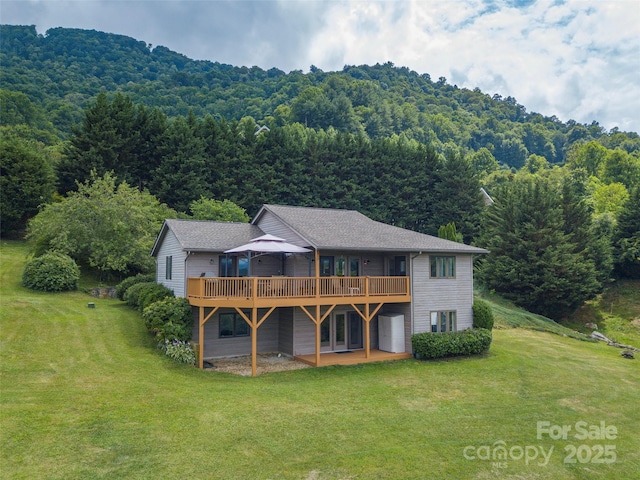 back of house featuring a yard and a wooden deck