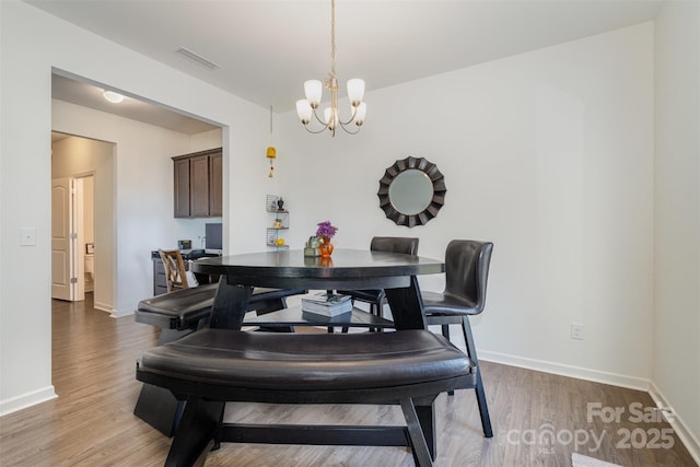 dining area featuring a chandelier and hardwood / wood-style floors