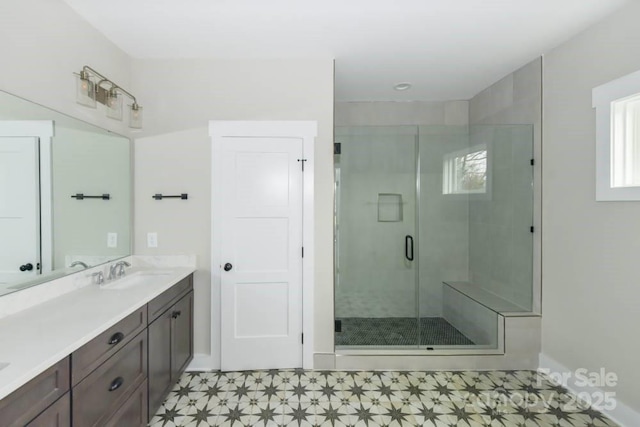 bathroom featuring vanity and a shower with shower door