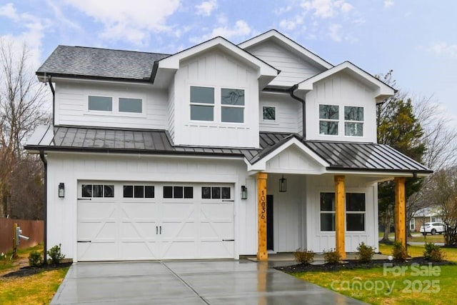 modern farmhouse featuring covered porch and a garage